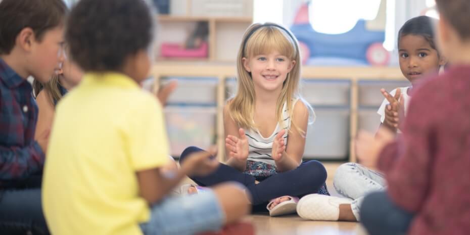 children sat in a circle playing a game