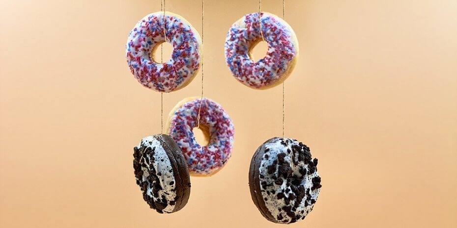 multicolour doughnuts dangling on strings